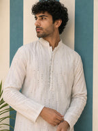 Man wearing AAINA ivory mirror work kurta - side pose