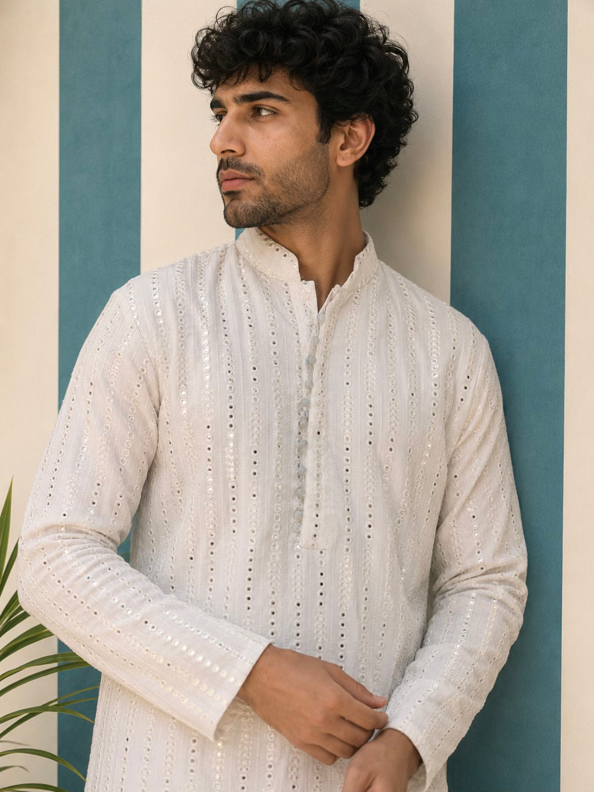 Man wearing AAINA ivory mirror work kurta - side pose