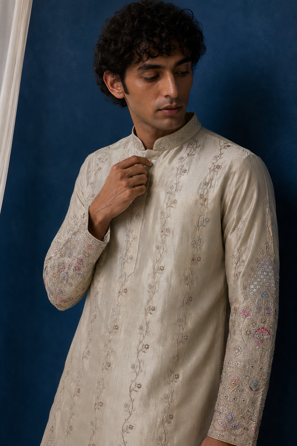 Close-up of embroidered hem border and cuff detail on NOOR kurta