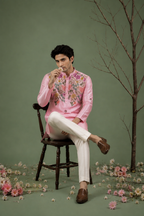  Man sitting wearing pink floral embroidered kurta - styled shot